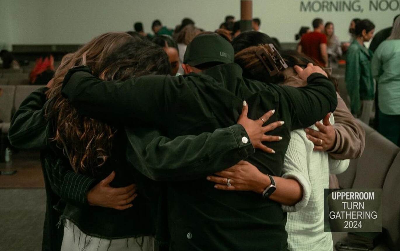 A family hugging and praying together